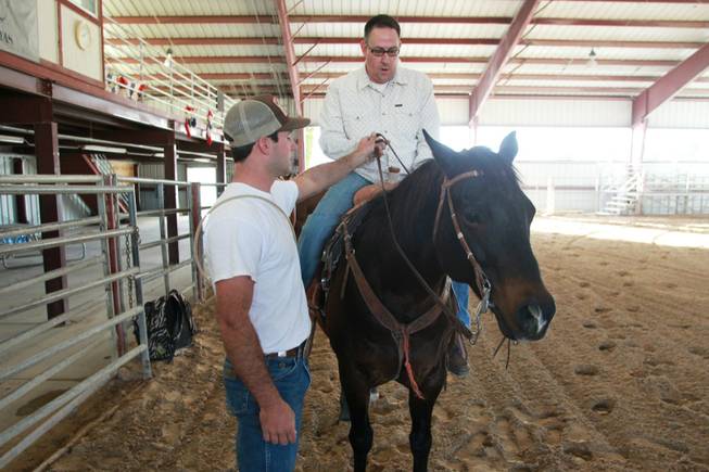 Las Vegas Sun sports editor Ray Brewer UNLV rodeo cowboy Tyler Mitchell gives Brewer pointers on how to ride  Nov. 2, 2012.